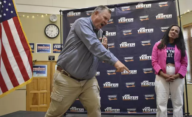 U.S. Sen. Jon Tester, D-Mont., leads a cheer at a rally with Planned Parenthood Action Fund President Alexis McGill Johnson, Thursday, Sept. 5, 2024, in Bozeman, Mont. (AP Photo/Matthew Brown)