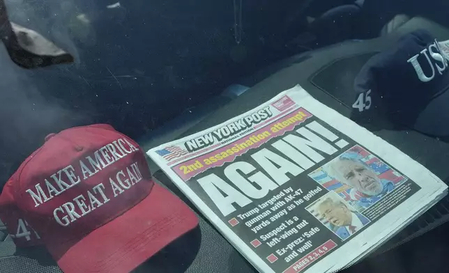 A newspaper is displayed in a vehicle outside of the Mar-a-Lago estate after the apparent assassination attempt of Republican presidential nominee and former President Donald Trump Monday, Sept. 16, 2024, in Palm Beach, Fla. (AP Photo/Lynne Sladky)