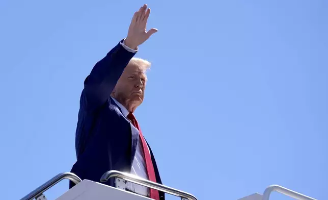 Republican presidential nominee former President Donald Trump waves as he boards a plane at Harry Reid International Airport after a campaign trip, Saturday, Sept.14, 2024, in Las Vegas. (AP Photo/Alex Brandon)