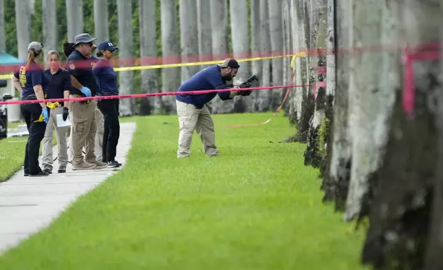 Law enforcement officials work outside of the Trump International Golf Club after the apparent assassination attempt of Republican presidential nominee and former President Donald Trump Monday, Sept. 16, 2024, in West Palm Beach, Fla. (AP Photo/Lynne Sladky)