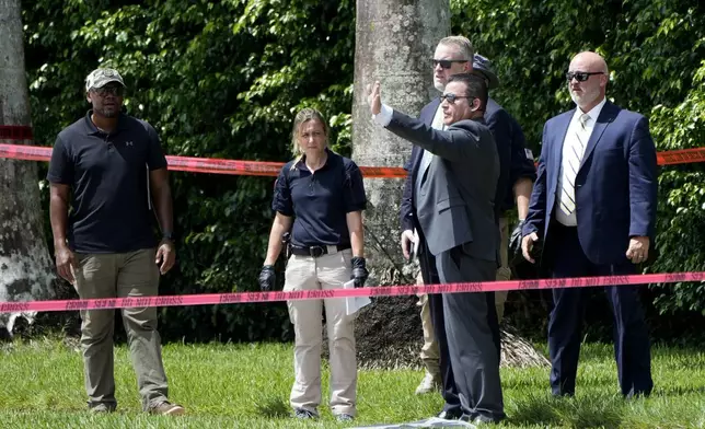 Law enforcement officials work outside of the Trump International Golf Club after the apparent assassination attempt of Republican presidential nominee and former President Donald Trump Monday, Sept. 16, 2024, in West Palm Beach, Fla. (AP Photo/Lynne Sladky)