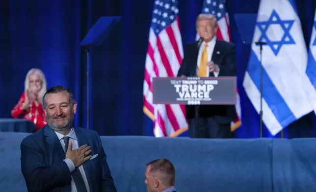 Sen. Ted Cruz, R-Texas, left, rises to greet people as Republican presidential candidate former President Donald Trump speaks during a "Fighting Anti-Semitism in America" event, Thursday, Sept. 19 2024, in Washington. (AP Photo/Jose Luis Magana)