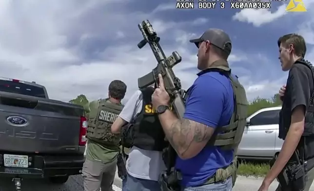 In this image taken from police body camera video and released by the Martin County, Fla., Sheriff’s Office, law enforcement officers prepare to arrest Ryan Routh, the man suspected in the apparent assassination attempt of Donald Trump, Sunday, Sept. 15, 2024. (Martin County Sheriff’s Office via AP)