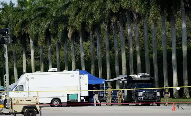 Law enforcement officials work outside of Trump International Golf Club after the apparent assassination attempt of Republican presidential nominee and former President Donald Trump Monday, Sept. 16, 2024, in West Palm Beach, Fla. (AP Photo/Lynne Sladky)