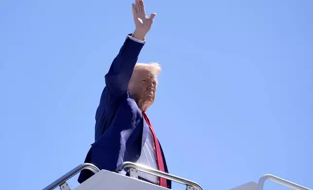 Republican presidential nominee former President Donald Trump waves as he boards a plane at Harry Reid International Airport after a campaign trip, Saturday, Sept.14, 2024, in Las Vegas. (AP Photo/Alex Brandon)