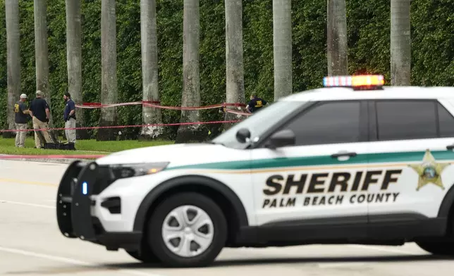 Law enforcement officials work at the scene at the Trump International Golf Club in the aftermath of the apparent assassination attempt of Republican presidential nominee and former President Donald Trump Tuesday, Sept. 17, 2024, in West Palm Beach, Fla. (AP Photo/Lynne Sladky)