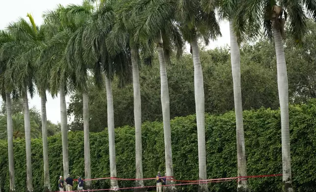 Law enforcement officials work at the scene of the Trump International Golf Club in the aftermath of the apparent assassination attempt of Republican presidential nominee and former President Donald Trump Tuesday, Sept. 17, 2024, in West Palm Beach, Fla. (AP Photo/Lynne Sladky)