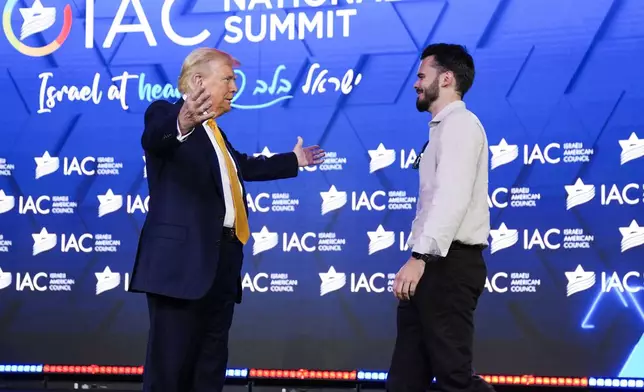 Republican presidential candidate former President Donald Trump greets Andrey Koslov, an Israeli who was taken hostage by Hamas on Oct. 7, 2023 and rescued by by Israeli special forces on June 8, 2024, at the Israeli American Council National Summit, Thursday, Sept. 19, 2024, in Washington. (AP Photo/Evan Vucci)