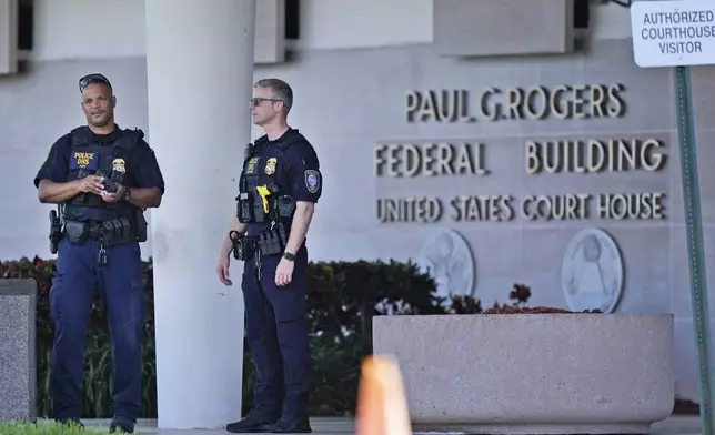 Department of Homeland Security officers patrol outside the Paul G. Rogers Federal Building and U.S. Courthouse, where a man suspected in an apparent assassination attempt targeting former President Donald Trump, was charged with federal gun crimes, Monday, Sept. 16, 2024, in West Palm Beach, Fla. (AP Photo/Wilfredo Lee)