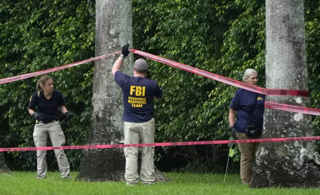 Law enforcement officials work at the scene of the Trump International Golf Club in the aftermath of the apparent assassination attempt of Republican presidential nominee and former President Donald Trump Tuesday, Sept. 17, 2024, in West Palm Beach, Fla. (AP Photo/Lynne Sladky)