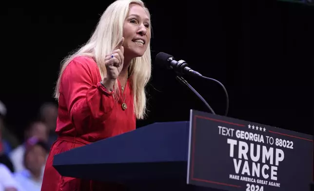 Rep. Marjorie Taylor Greene, R-Ga., speaks before Republican presidential candidate former President Donald Trump arrives to deliver remarks on the tax code, and manufacturing at the Johnny Mercer Theatre Civic Center, Tuesday, Sept. 24, 2024, in Savannah, Ga. (AP Photo/Evan Vucci)