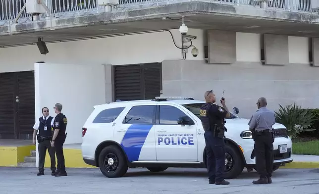 Department of Homeland Security officers patrol outside the Paul G. Rogers Federal Building and U.S. Courthouse, where a man suspected in an apparent assassination attempt targeting former President Donald Trump, was charged with federal gun crimes, Monday, Sept. 16, 2024, in West Palm Beach, Fla. (AP Photo/Wilfredo Lee)