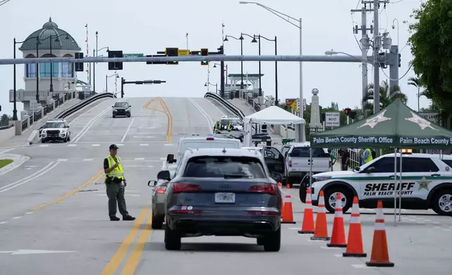 A Palm Beach County Sheriff's officer works at a checkpoint near the bridge that leads to the Mar-a-Lago estate after the apparent assassination attempt of Republican presidential nominee and former President Donald Trump Monday, Sept. 16, 2024, in West Palm Beach, Fla. (AP Photo/Lynne Sladky)