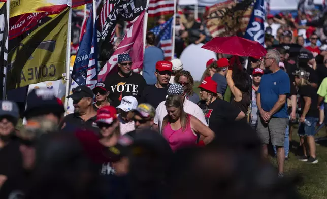 People wait in line to attend a town hall with Republican presidential candidate former President Donald Trump at the Dort Financial Center, Tuesday, Sept. 17, 2024, in Flint, Mich. (AP Photo/Evan Vucci)