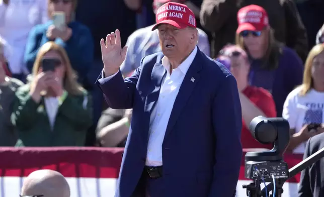 Republican presidential nominee former President Donald Trump waves as he departs a campaign event at Central Wisconsin Airport, Saturday, Sept. 7, 2024, in Mosinee, Wis. (AP Photo/Morry Gash)