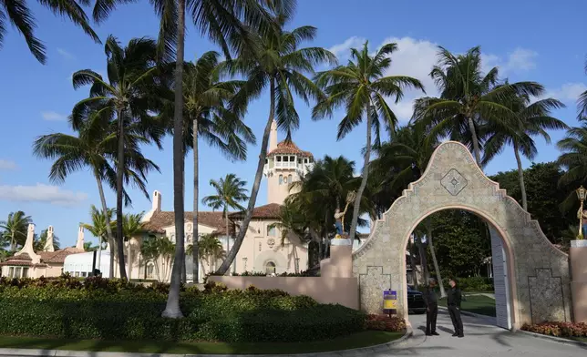 FILE - Security agents talk at the entrance to former President Donald Trump's Mar-a-Lago estate, March 31, 2023, in Palm Beach, Fla. (AP Photo/Rebecca Blackwell, File)