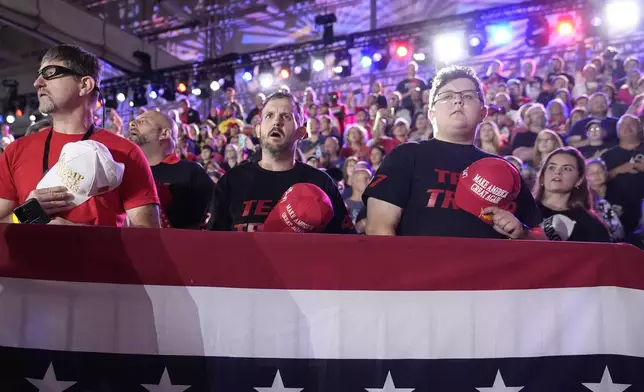 Supporters stand for the National Anthem before Republican presidential nominee former President Donald Trump speaks at a town hall campaign event at Macomb Community College, Friday, Sept. 27, 2024, in Warren, Mich. (AP Photo/Alex Brandon)