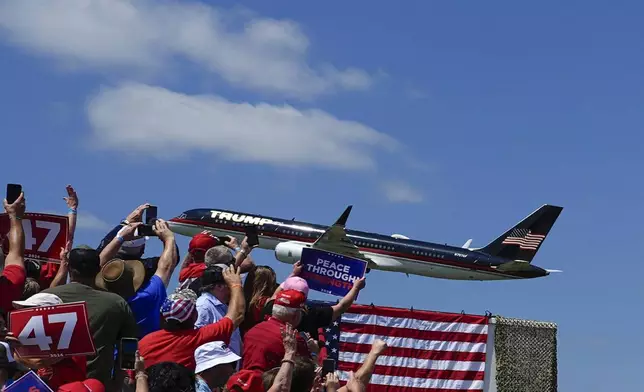 The plane carrying Republican presidential nominee former President Donald Trump arrives for a campaign rally at North Carolina Aviation Museum, Wednesday, Aug. 21, 2024, in Asheboro, N.C. (AP Photo/Julia Nikhinson)