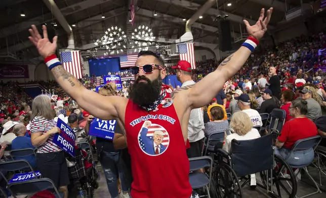 A supporter dances before Republican presidential nominee former President Donald Trump speaks at a campaign rally at 1st Summit Arena at the Cambria County War Memorial, in Johnstown, Pa., Friday, Aug. 30, 2024. (AP Photo/Rebecca Droke)