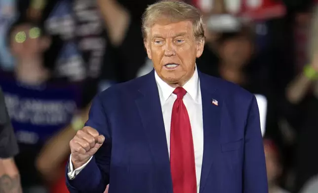 Republican presidential nominee former President Donald Trump arrives for a town hall event at Macomb Community College Friday, Sept. 27, 2024, in Warren, Mich. (AP Photo/Paul Sancya)