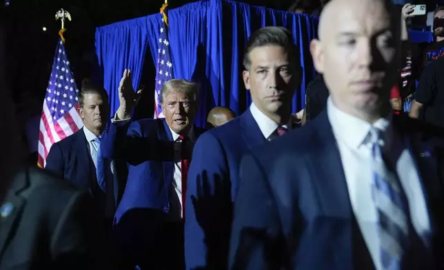 Republican presidential candidate former President Donald Trump, center, gestures as he is introduced for a town hall event at the Dort Financial Center, Tuesday, Sept. 17, 2024, in Flint, Mich. (AP Photo/Evan Vucci)