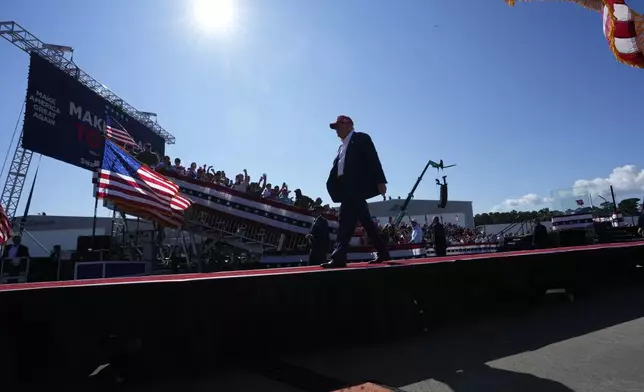 Republican presidential nominee former President Donald Trump walks from the stage after speaking at a campaign rally at Wilmington International Airport, Saturday, Sept. 21, 2024, in Wilmington, N.C. (AP Photo/Alex Brandon)