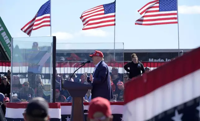 Republican presidential nominee former President Donald Trump speaks behind bullet-resistant glass during a campaign event at Central Wisconsin Airport, Saturday, Sept. 7, 2024, in Mosinee, Wis. (AP Photo/Alex Brandon)