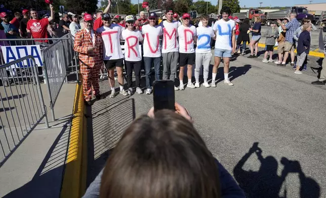 Supporters pose for a photo while waiting for Republican presidential nominee former President Donald Trump to arrive at a rally, Saturday, Sept. 28, 2024, in Prairie du Chien, Wis. (AP Photo/Charlie Neibergall)