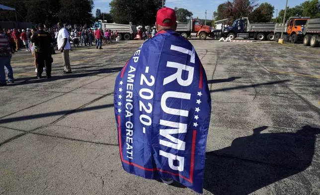 A supporter waits for Republican presidential nominee former President Donald Trump to arrive at a rally, Saturday, Sept. 28, 2024, in Prairie du Chien, Wis. (AP Photo/Charlie Neibergall)