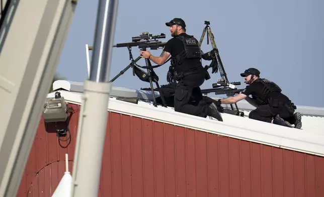 FILE - Police snipers return fire after shots were fired while Republican presidential candidate former President Donald Trump was speaking at a campaign event in Butler, Pa., July 13, 2024. (AP Photo/Gene J. Puskar, File)