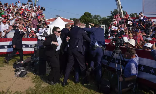 FILE - Republican presidential candidate former President Donald Trump is surrounded by U.S. Secret Service agents at a campaign rally, July 13, 2024, in Butler, Pa. (AP Photo/Evan Vucci, File)