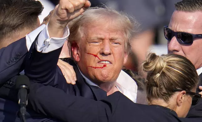 FILE - Republican presidential candidate former President Donald Trump reacts following an assassination attempt at a campaign event in Butler, Pa., July 13, 2024. (AP Photo/Gene J. Puskar, File)