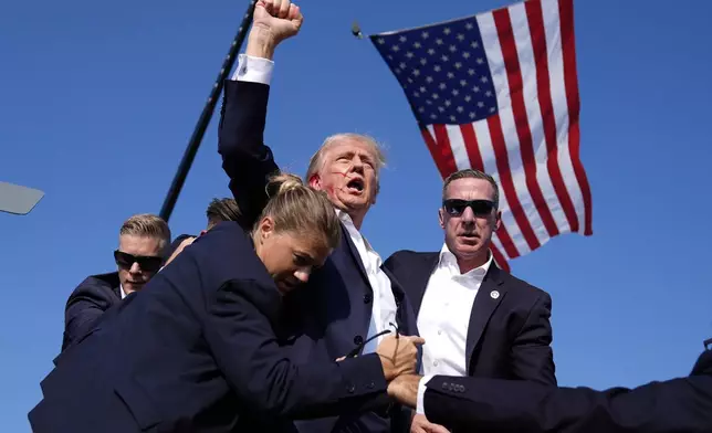 FILE - Republican presidential candidate former President Donald Trump is surrounded by U.S. Secret Service agents at a campaign rally, July 13, 2024, in Butler, Pa. (AP Photo/Evan Vucci, File)