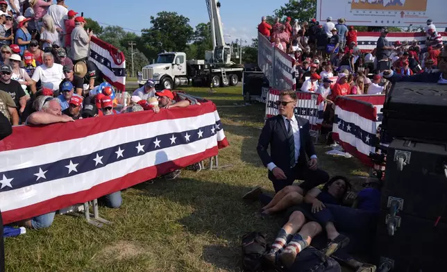 FILE - People react during a campaign rally with Republican presidential candidate former President Donald Trump at a campaign rally, July 13, 2024, in Butler, Pa. (AP Photo/Evan Vucci, File)