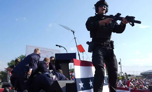 FILE - Republican presidential candidate former President Donald Trump is covered by U.S. Secret Service agents at a campaign rally, July 13, 2024, in Butler, Pa. (AP Photo/Evan Vucci, File)