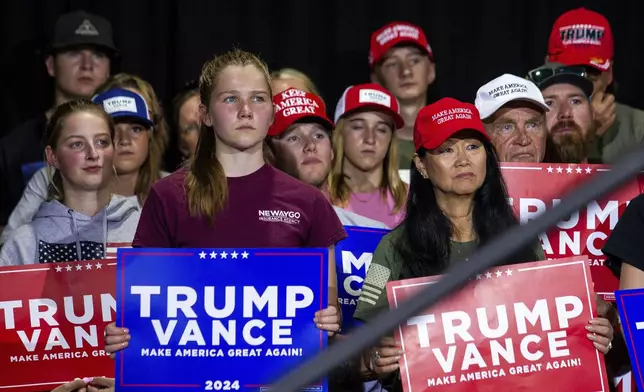 Supporters listens as Republican vice presidential nominee JD Vance speaks during a campaign stop at Apple Valley Events in Sparta, Mich., Tuesday, Sept. 17, 2024. (Isaac Ritchey/The Grand Rapids Press via AP)