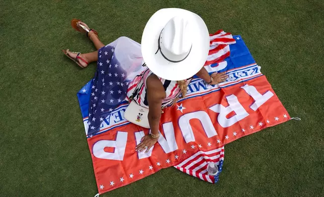 FILE - A supporter waits for the start of Republican presidential candidate former President Donald Trump's campaign rally in Doral, Fla., July 9, 2024. (AP Photo/Rebecca Blackwell, File)