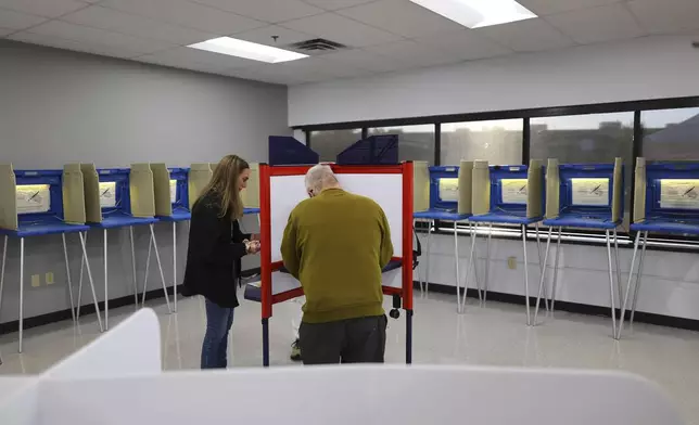 Minneapolis residents cast their votes at the City of Minneapolis early voting center, Friday, September 20, 2024, in Minneapolis, Minn. (AP Photo/Adam Bettcher)