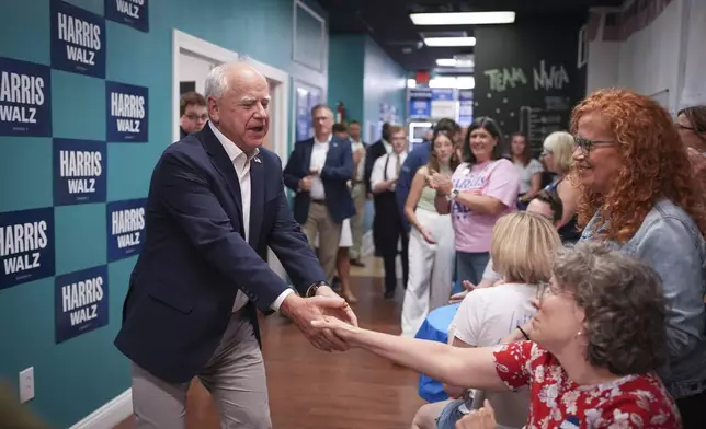 Democratic vice presidential nominee Minnesota Gov. Tim Walz greets volunteers at an Erie Pennsylvania field office Thursday, Sept. 5, 2024, in Erie, Pa. (Glen Stubbe/Star Tribune via AP)