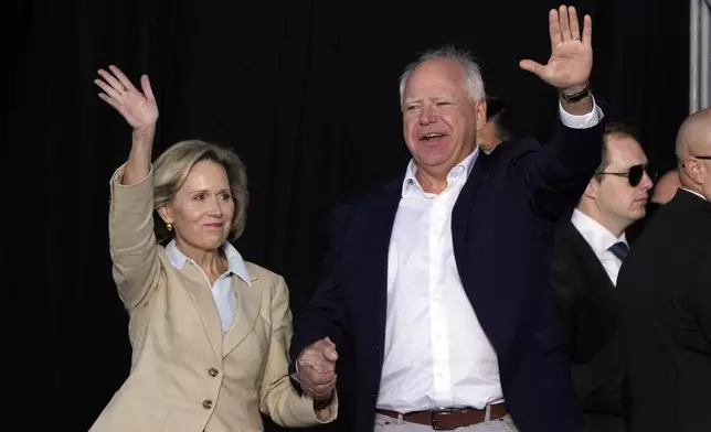 Democratic vice presidential nominee Minnesota Gov. Tim Walz and his wife Gwen arrive for a campaign stop at Laborfest Monday, Sept. 2, 2024, in Milwaukee. (AP Photo/Morry Gash)