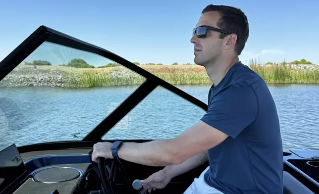 Mitch Lee, co-founder and CEO of Arc Boats, pilots an Arc Sport, an electric boat made by his California company, in the Sacramento-San Joaquin Delta near Bethel Island, Calif. on Wednesday, July 31, 2024. (AP Photo/Terry Chea)