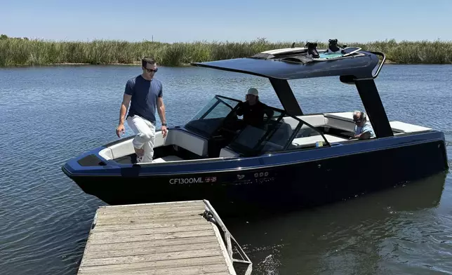 Mitch Lee, co-founder and CEO of Arc Boats, steps off an Arc Sport, an electric boat made by his California company, in the Sacramento-San Joaquin Delta near Bethel Island, Calif. on July 31, 2024. (AP Photo/Terry Chea)