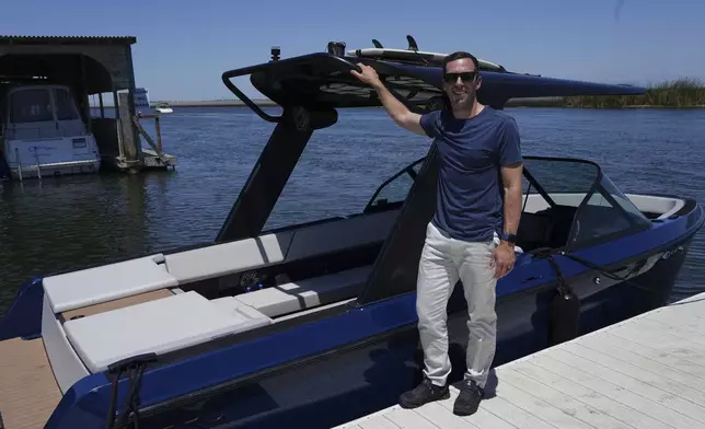 Mitch Lee, co-founder and CEO of Arc Boats, stands in front of an Arc Sport, an electric boat made by his California company, in Bethel Island, Calif. on Wednesday, July 31, 2024. (AP Photo/Terry Chea)