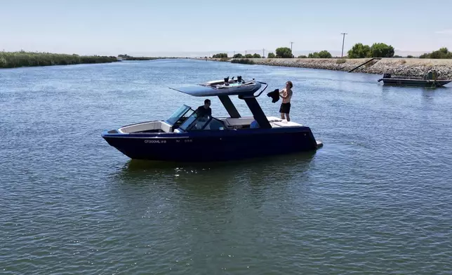 An electric sports boat made by California-based Arc Boats floats on the Sacramento-San Joaquin Delta near Bethel Island, Calif. on Wednesday, July 31, 2024. (AP Photo/Terry Chea)