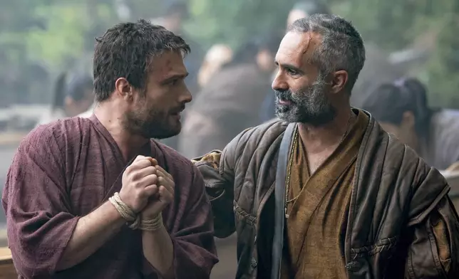 This image released by FX shows Cosmo Jarvis, left, and Nestor Carbonell in a scene from "Shogun." (Katie Yu/FX via AP)