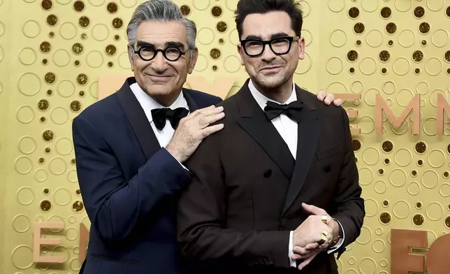 FILE - Eugene Levy, left, and Dan Levy appear at the 71st Primetime Emmy Awards in Los Angeles on Sept. 22, 2019. (Photo by Jordan Strauss/Invision/AP, File)