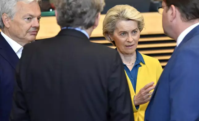 File - European Commission President Ursula von der Leyen, second right, speaks with from left, European Commissioner for Justice Didier Reynders, European Commissioner for Internal Market Thierry Breton and European Commissioner for Neighborhood and Enlargement Oliver Varhelyi during a meeting of the College of Commissioners at EU headquarters in Brussels, Friday, June 17, 2022. (AP Photo/Geert Vanden Wijngaert, File)