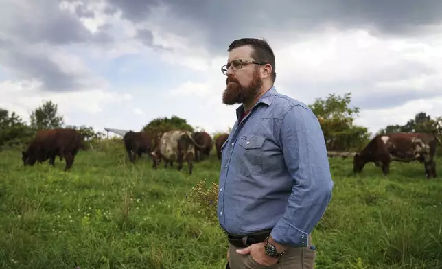 The Rev. Lee Scott stands in the pasture with his cows at Laurel Oak Farm in Butler, Pa., on Friday, Sept. 6, 2024. (AP Photo/Jessie Wardarski)