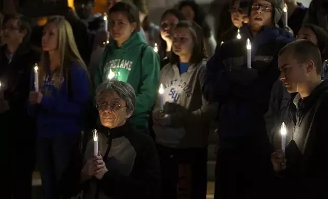 FILE - In this Nov. 19, 2013 file photo, a small group of death penalty opponents stand outside St. Francis Xavier Church during a vigil in protest of the scheduled execution of Missouri death row inmate Joseph Paul Franklin in St. Louis. (AP Photo/Jeff Roberson, File)