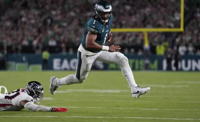 Philadelphia Eagles quarterback Jalen Hurts (1) runs with the ball during the second half of an NFL football game against the Atlanta Falcons on Monday, Sept. 16, 2024, in Philadelphia. (AP Photo/Matt Rourke)